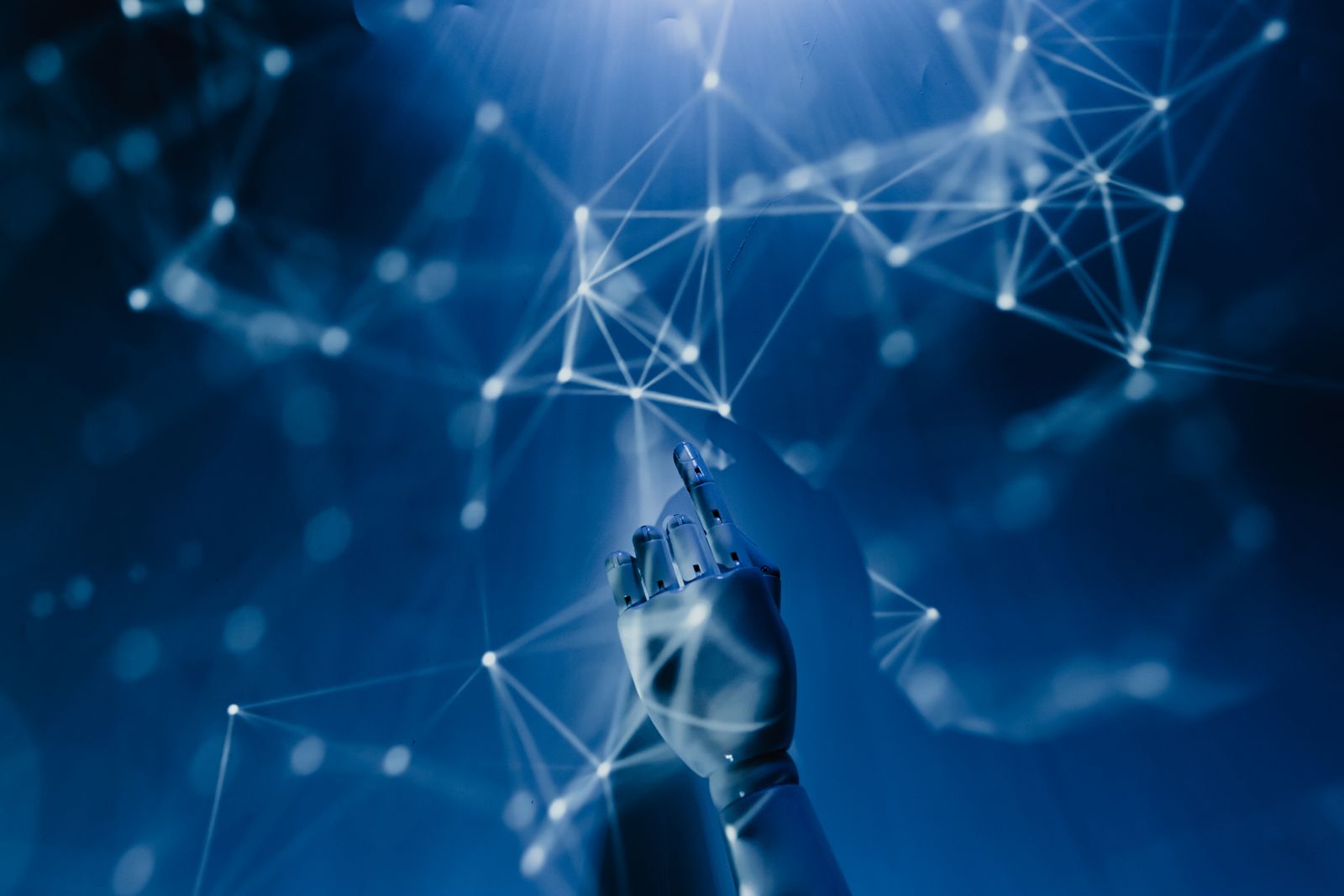 Robotic hand reaching into a glowing data network
