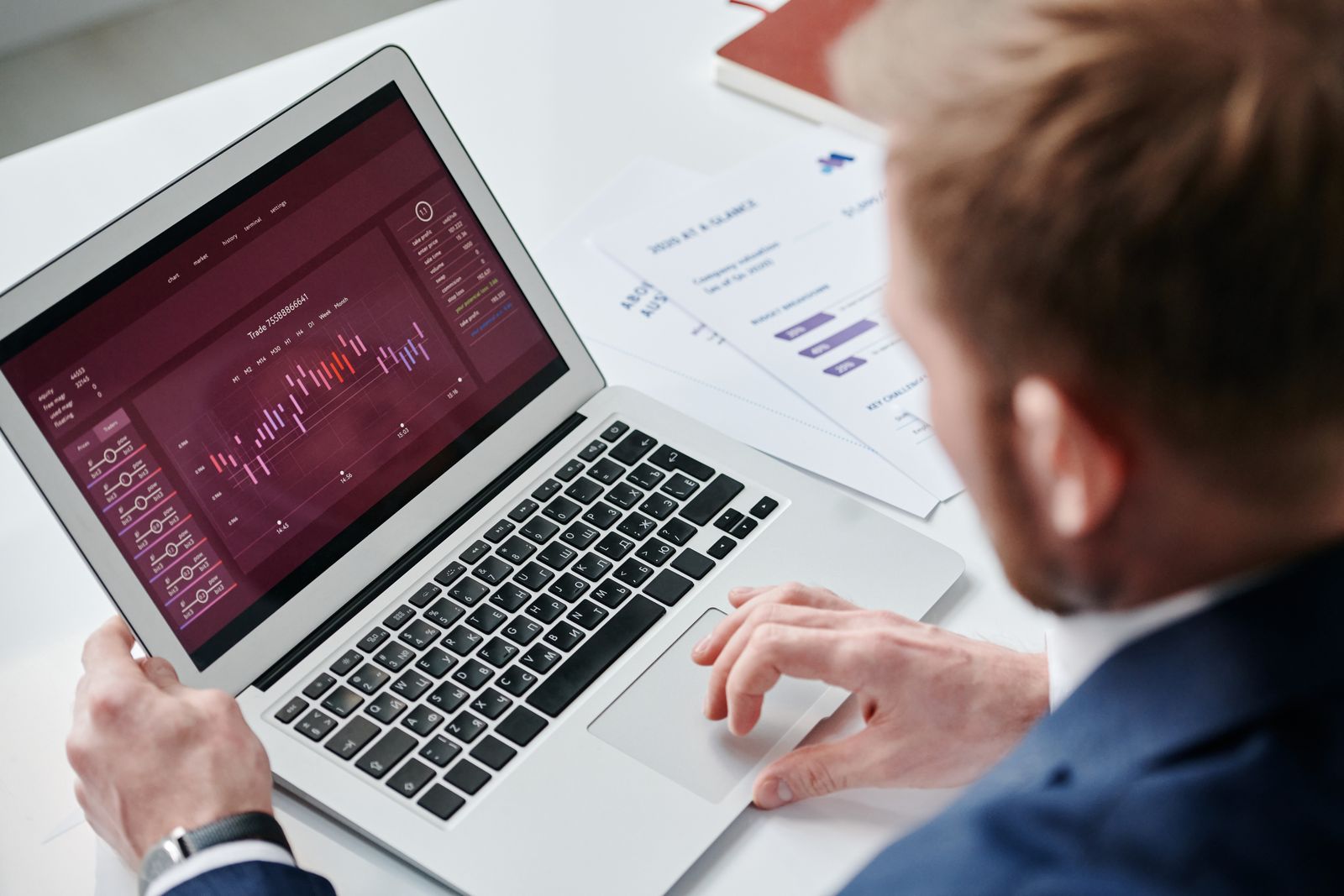 Analyst reviewing a business analytics dashboard on a laptop