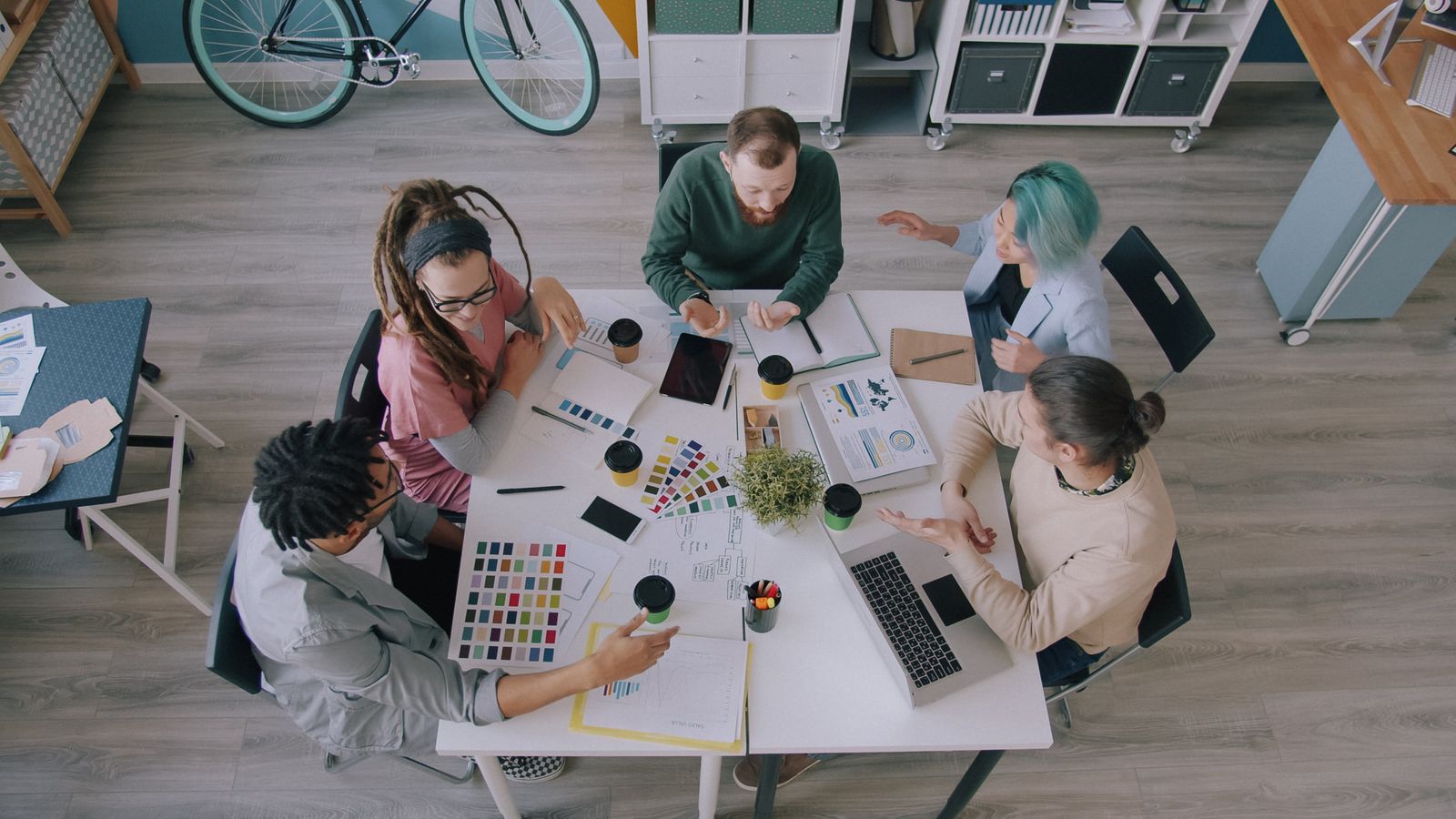 Designers and developers planning a project around a shared table